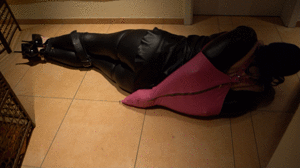 www.bondagecrossdresser.com - Helpless bound on the Floor with the Pink Armbinder thumbnail